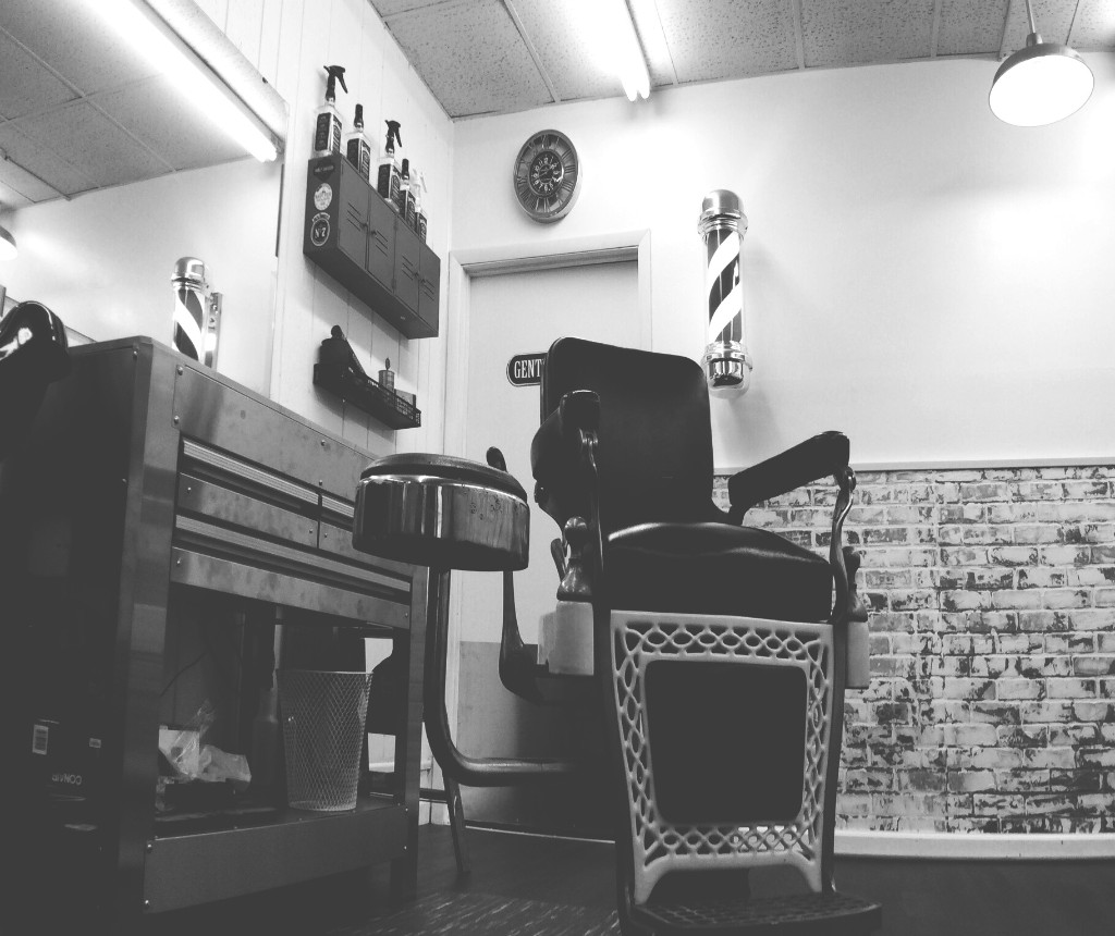 Interior of Zak's Barbershop in St. Peters — classic barber chairs and barber poles